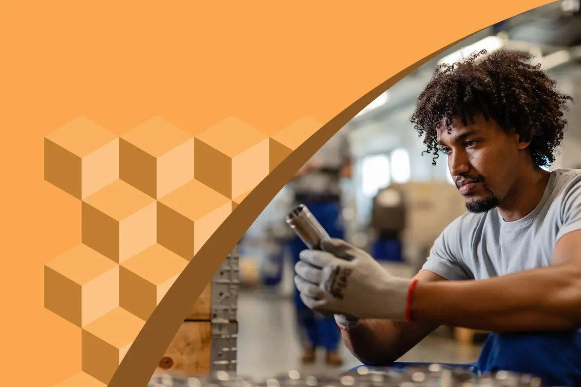 Worker examining metal pipe