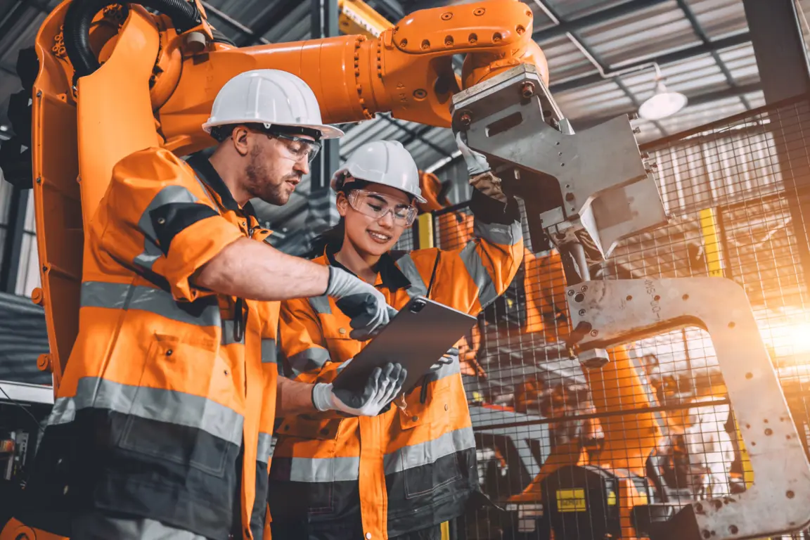 Two workers examine tablet